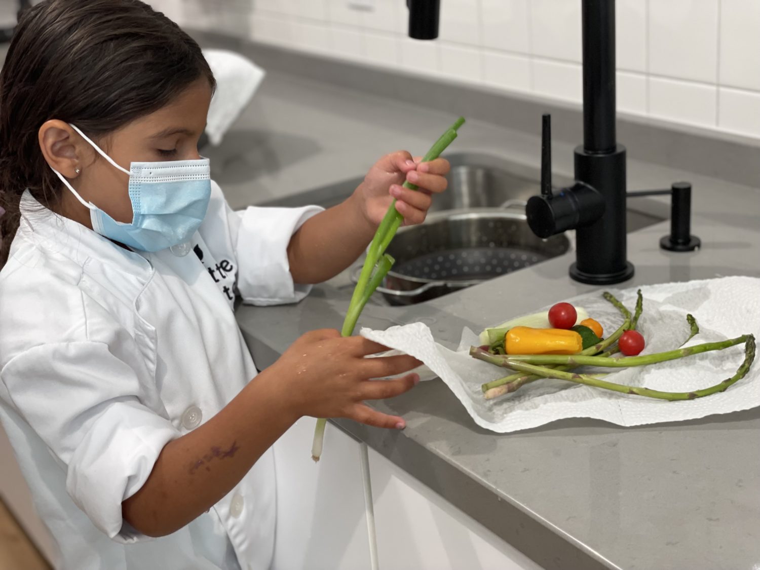 https://www.laweekly.com/wp-content/uploads/2021/08/Little-Kitchen-Academywashing-vegetables-Michele-Stueven.jpg